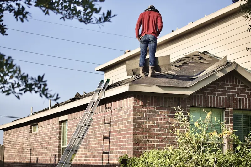 Professional roofer working on a residential roof in Fishers